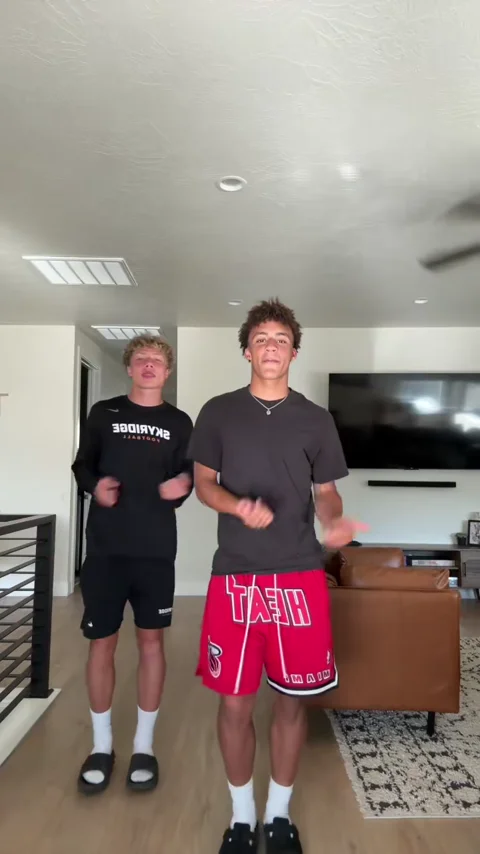 Two friends dancing in a living room